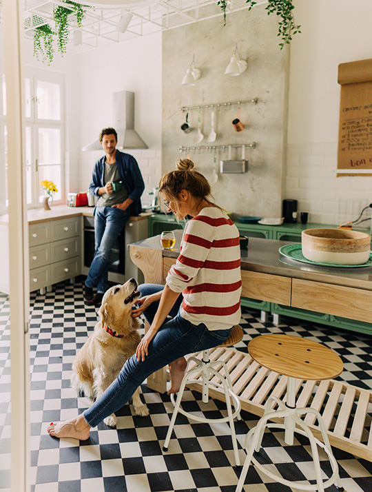 couple in the kitchen with their dog